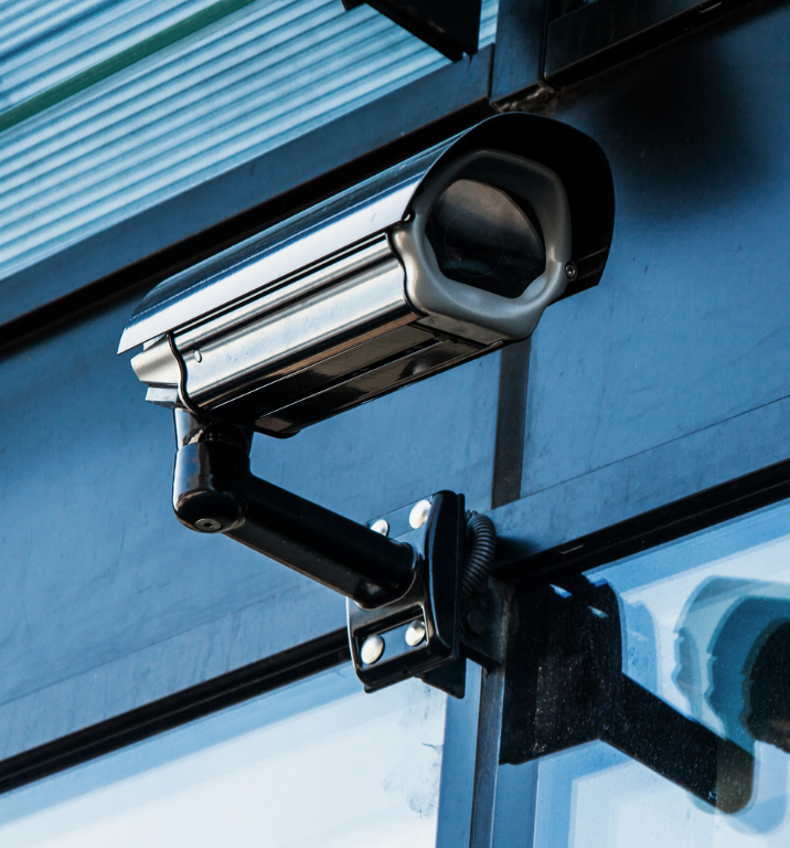 A security camera is mounted on the side of a building