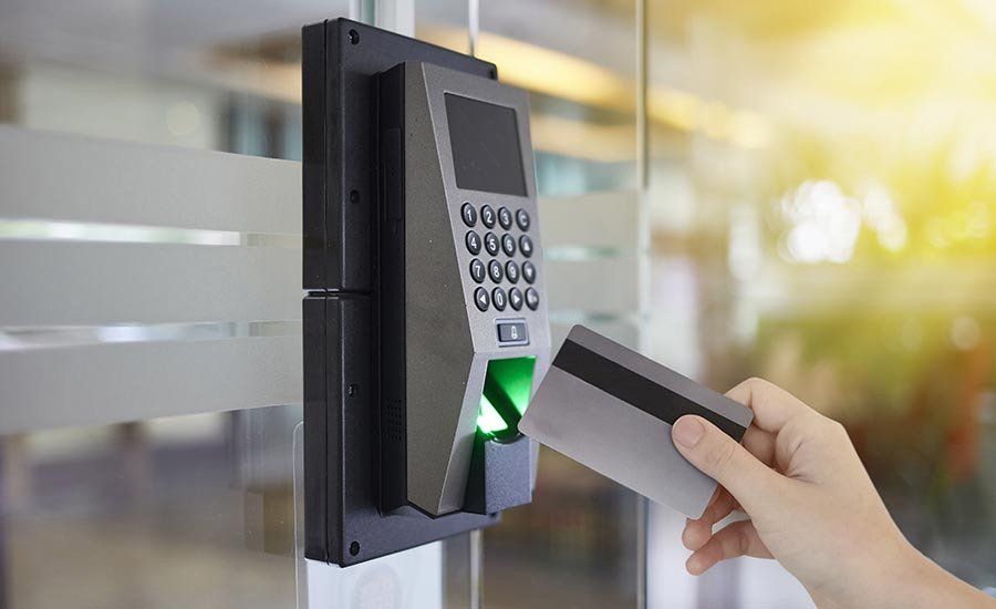 A person is using a credit card to open a door.
