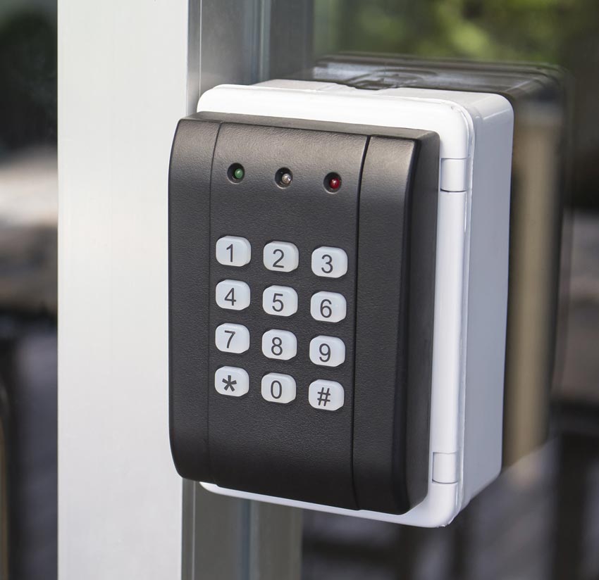A close up of a keypad on a glass door