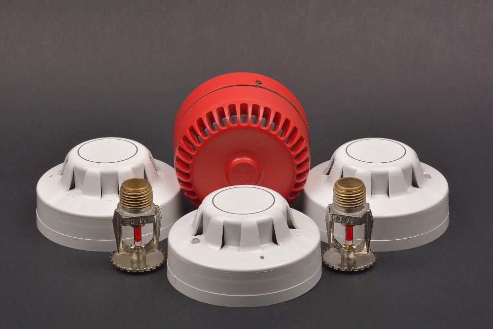 A group of fire alarms and sprinklers on a table