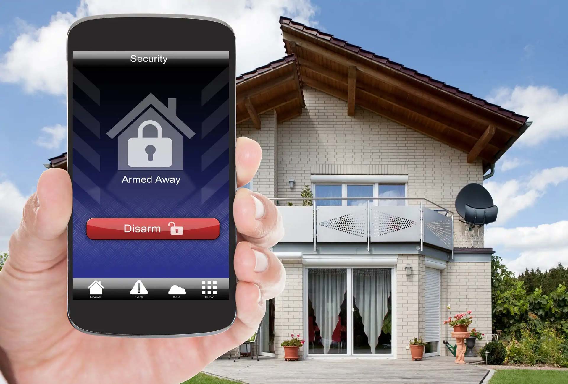 A person is holding a smart phone in front of a house