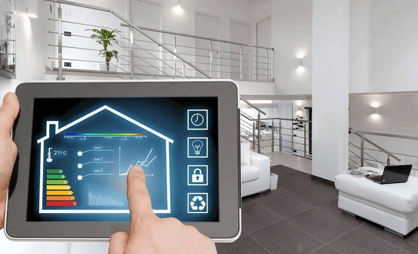 A person is holding a tablet with a house on the screen.
