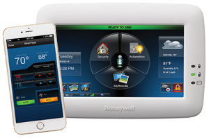 A phone is sitting next to a honeywell thermostat.