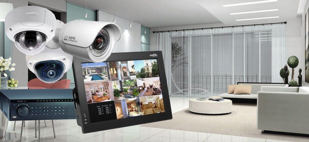 A living room with two security cameras and a monitor
