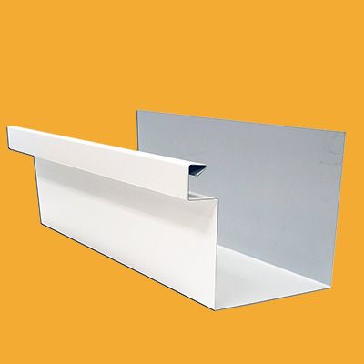 A white gutter is sitting on top of a yellow surface.