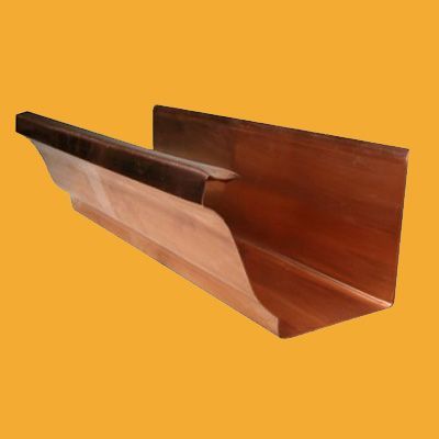 A close up of a copper gutter on a yellow background
