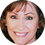 A close up of a woman 's face in a circle smiling.