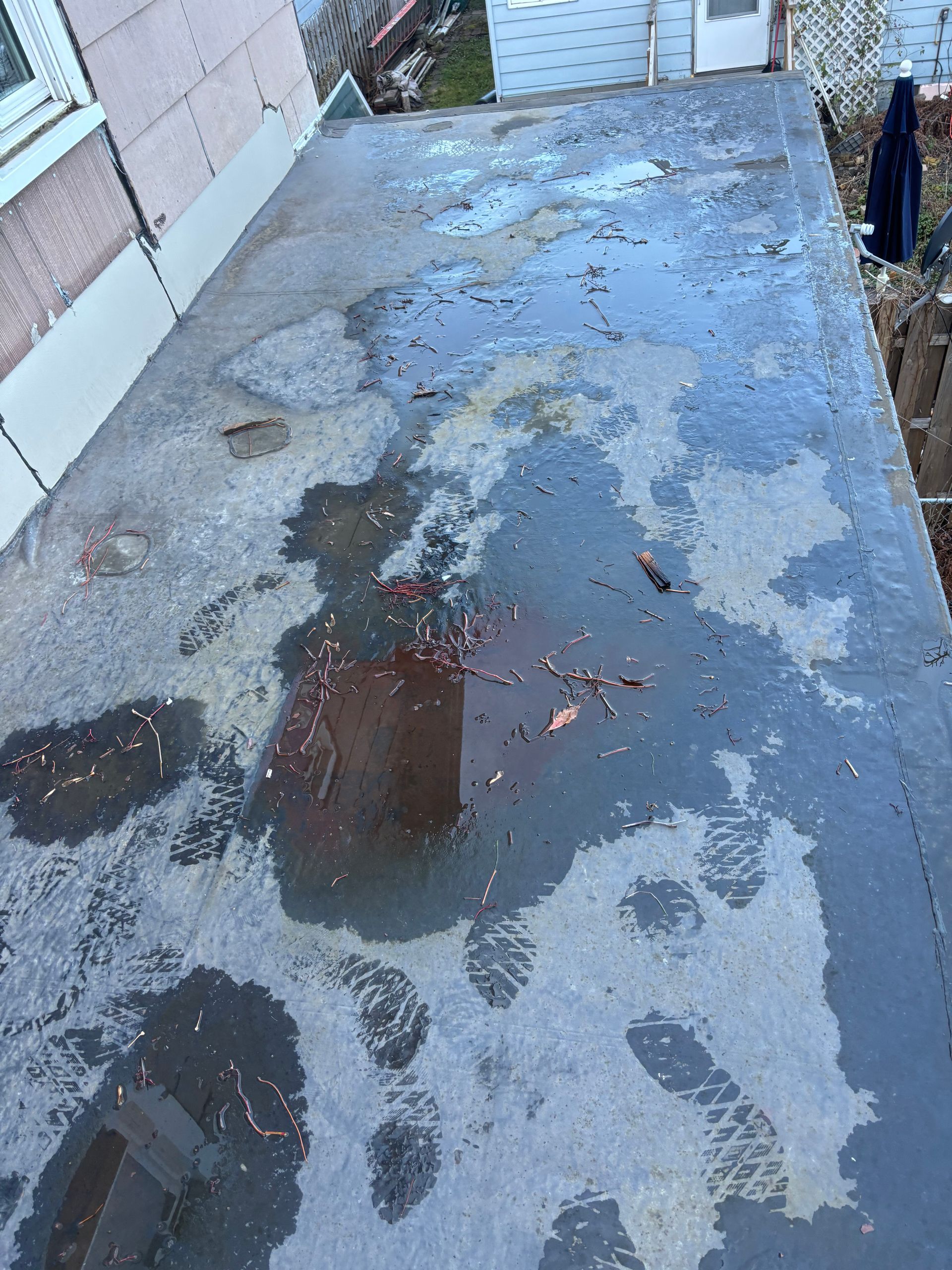 Wet concrete surface with footprints and debris.