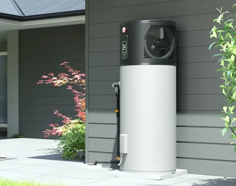 Heat Pump on a Wall of a House — Illawater Hot Water Services in East Corrimal, NSW