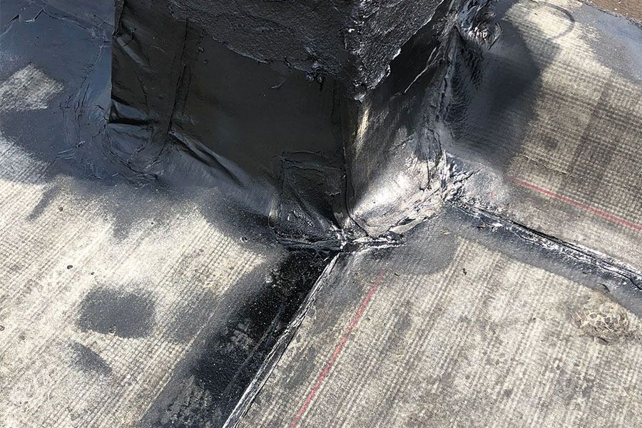 A close up of a roof with water coming out of it.