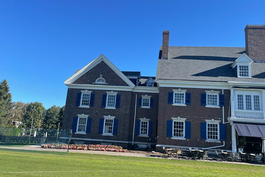 A large brick building with blue shutters on the windows