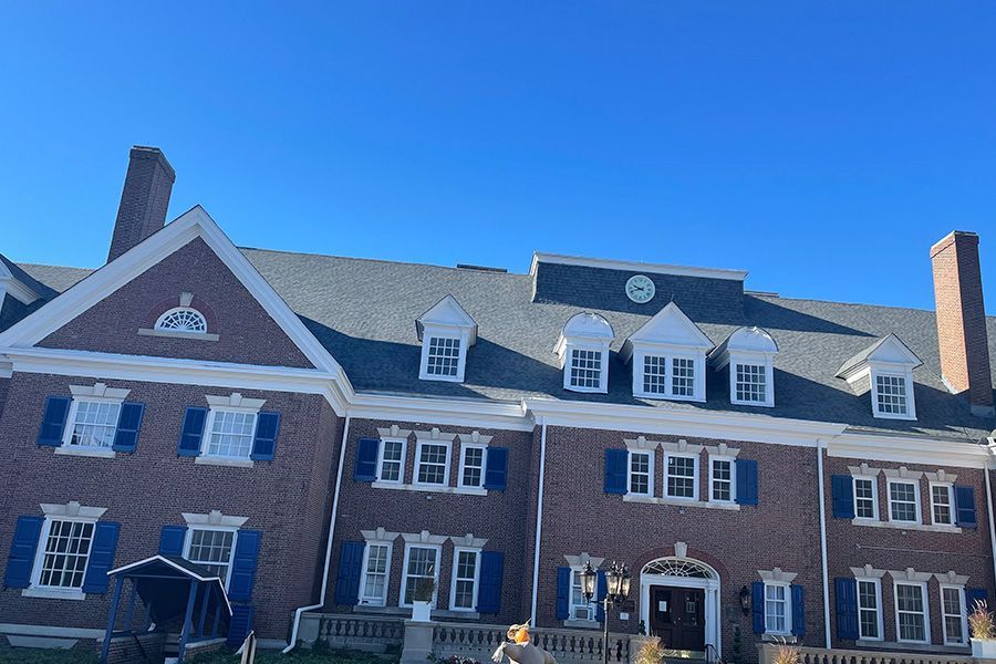 A large brick building with blue shutters on the windows