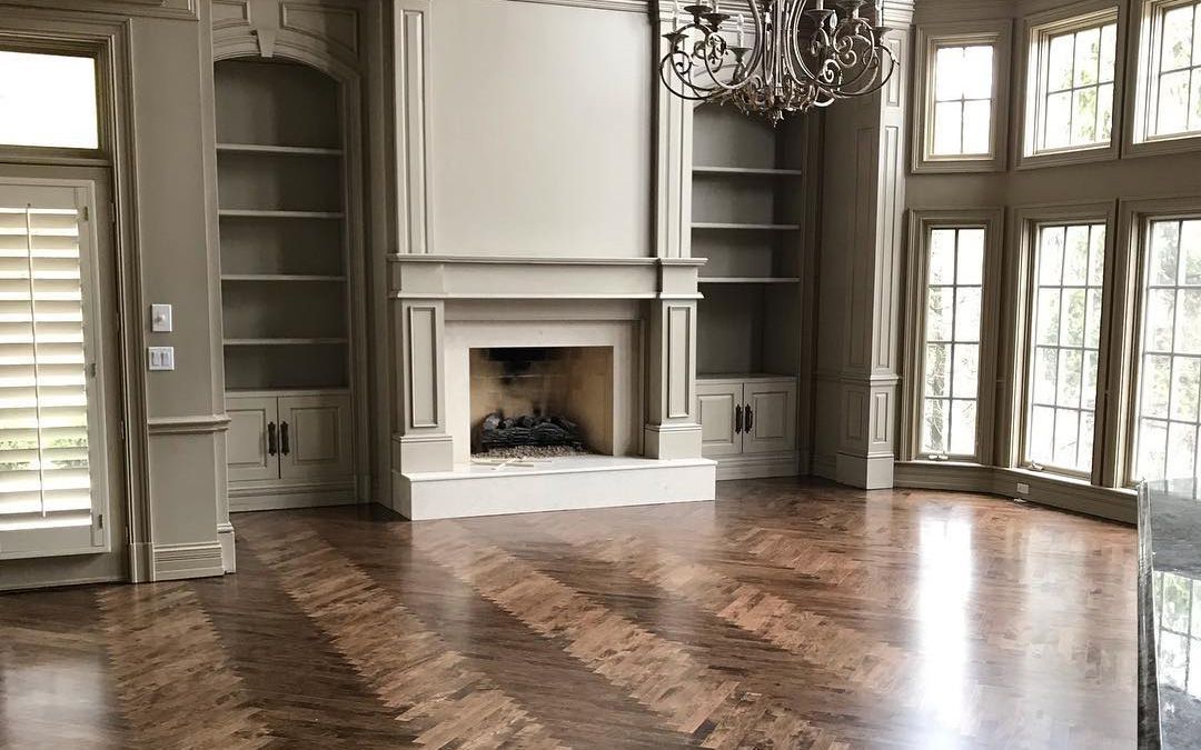 There is a fireplace in the middle of the room with a hardwood floor There is a fireplace in the middle of the room with a hardwood floor