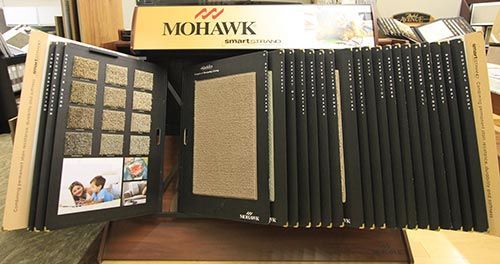 A display of mohawk carpet samples on a table