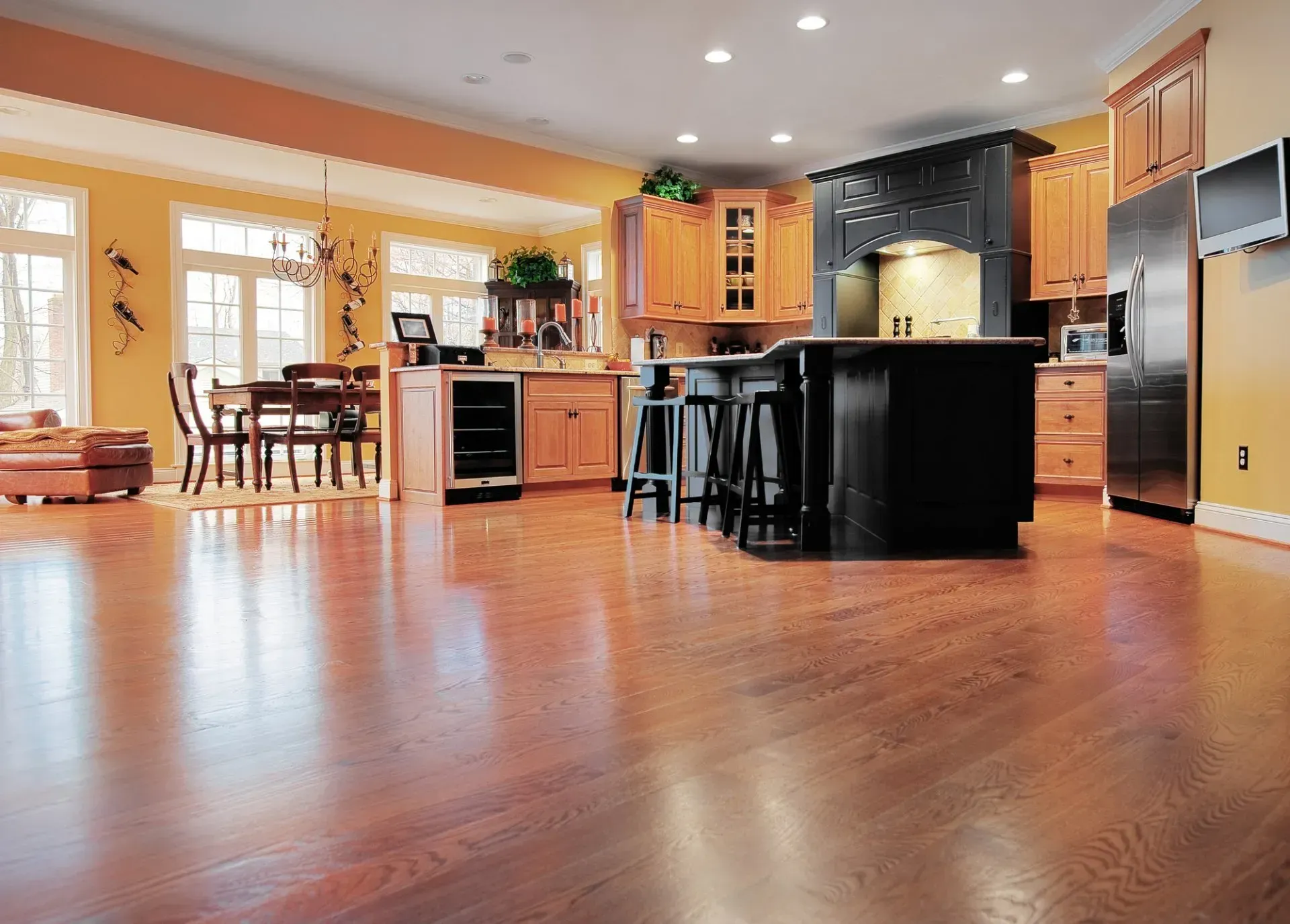 A large kitchen with hardwood floors and stainless steel appliances