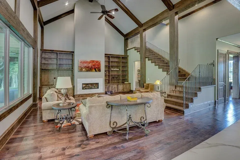A living room with a staircase leading up to the second floor