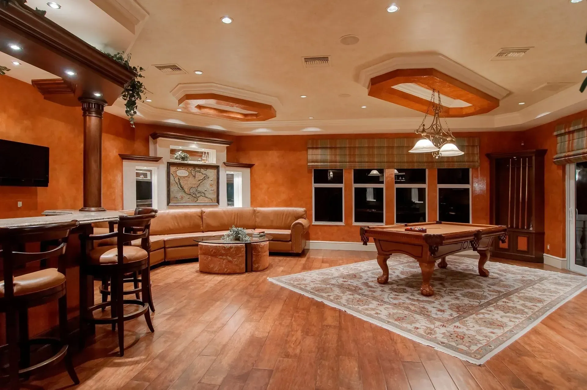 A living room with a pool table and a couch