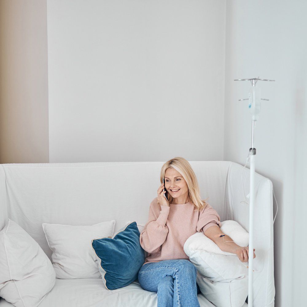Woman On Phone Having IV Therapy — Mooresville, NC — ReShape PLLC