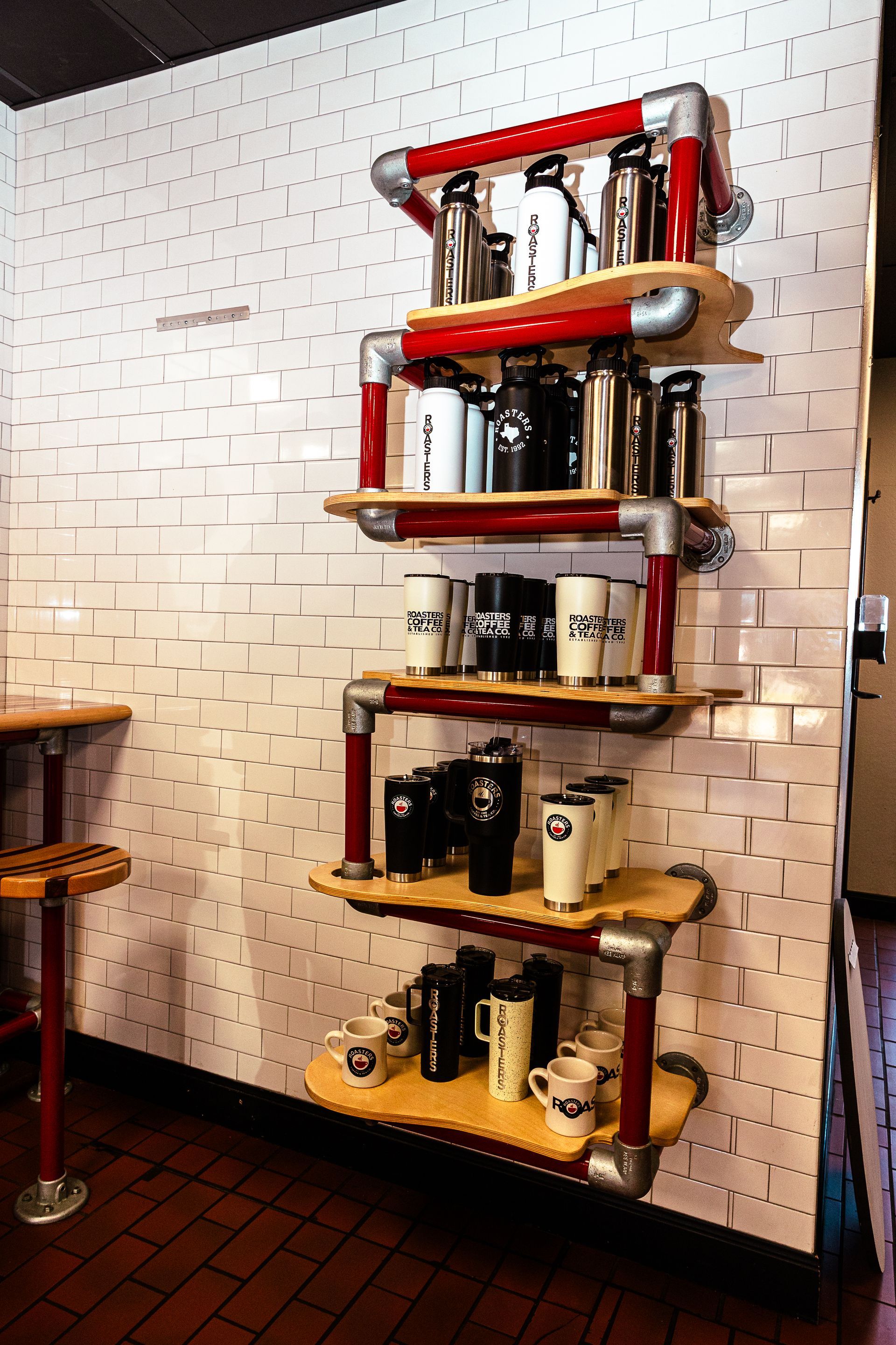 A display of coffee mugs and thermoses on shelves