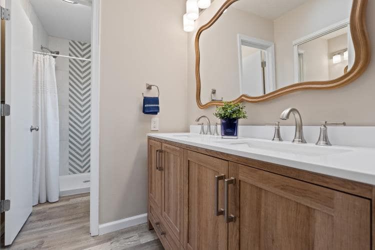 a bathroom with two sinks and a large mirror .