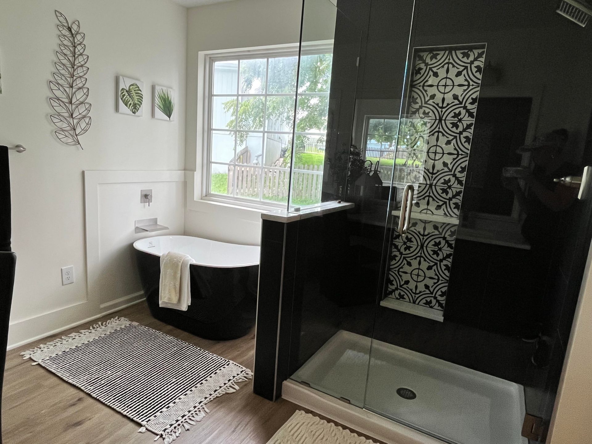 a bathroom with a tub and a walk in shower .