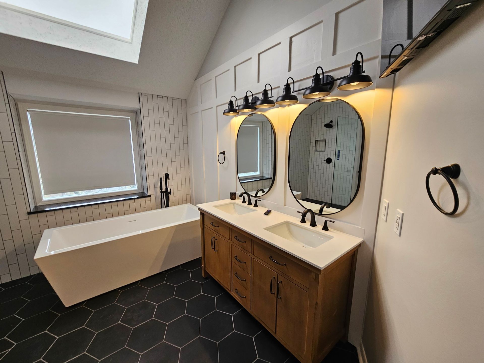 a bathroom with two sinks and a bathtub .