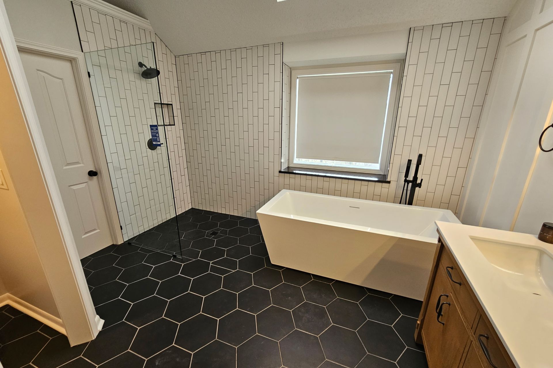 a bathroom with a bathtub and a walk in shower .