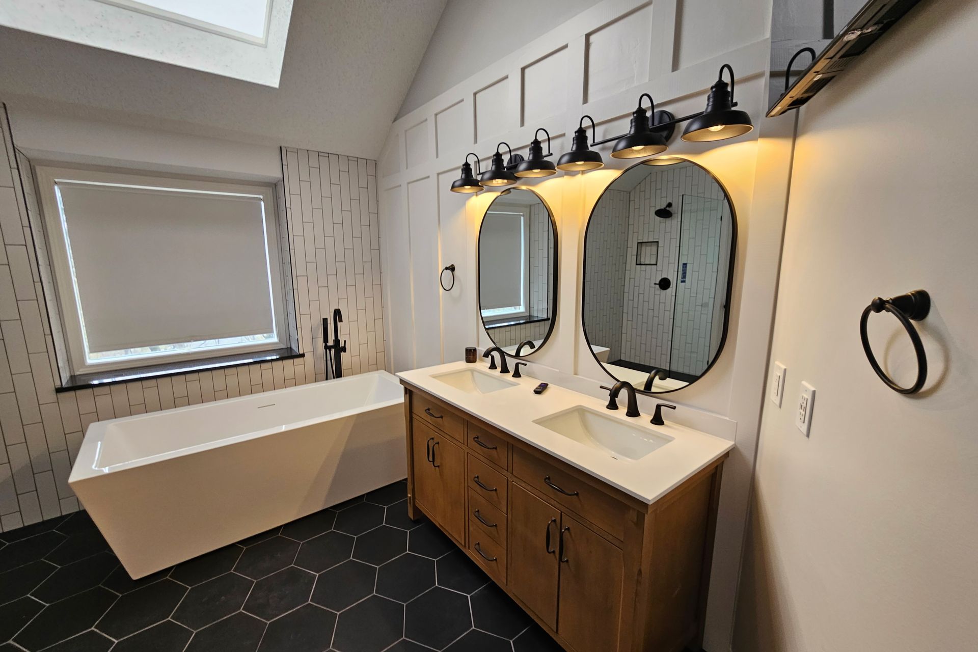 a bathroom with two sinks and a bathtub in Bonner Springs