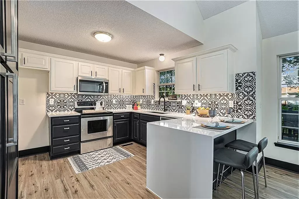 a kitchen with stainless steel appliances and white cabinets