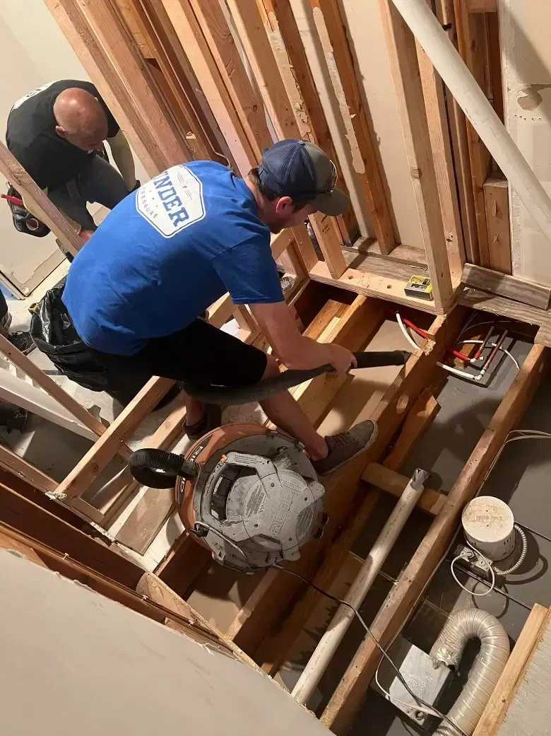 a man wearing a blue shirt doing bathroom remodeling in Belton Missouri 