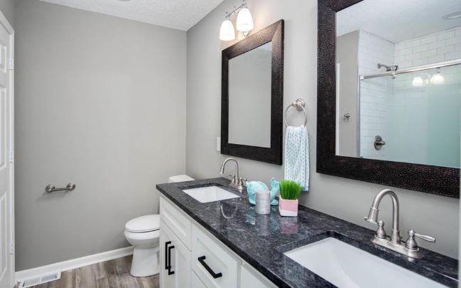 black glossy countertop with white under-mount sinks in bathroom, countertop inspiration from under pressure