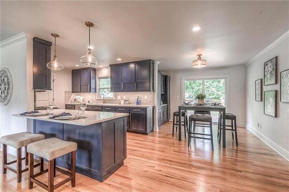 kitchen remodel with grey cabinets and island with counter seating

