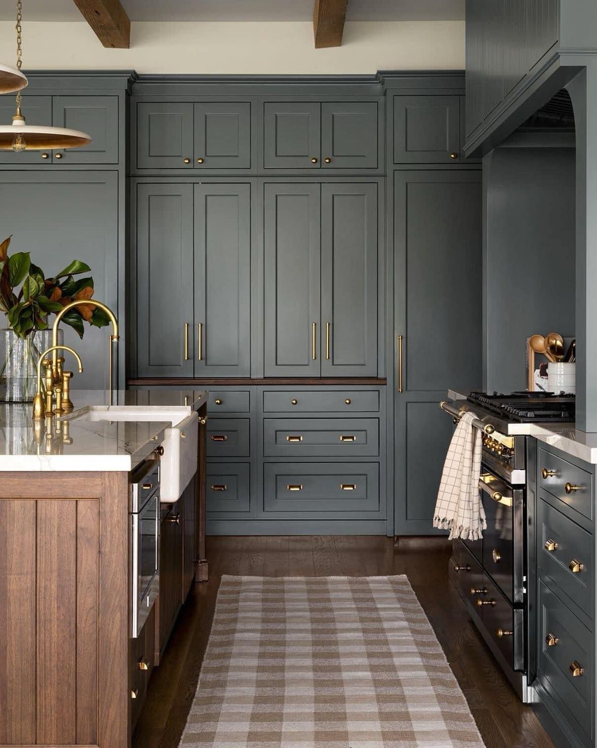 Custom navy blue kitchen cabinets with gold hardware in a Leawood home renovation.