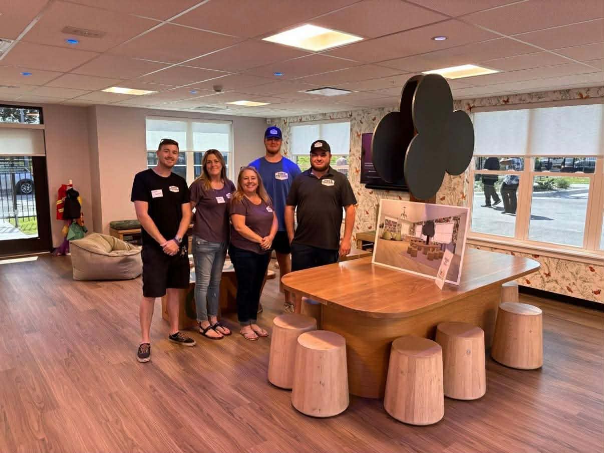 under pressure team taking photo after finishing kansas city commercial remodeling project