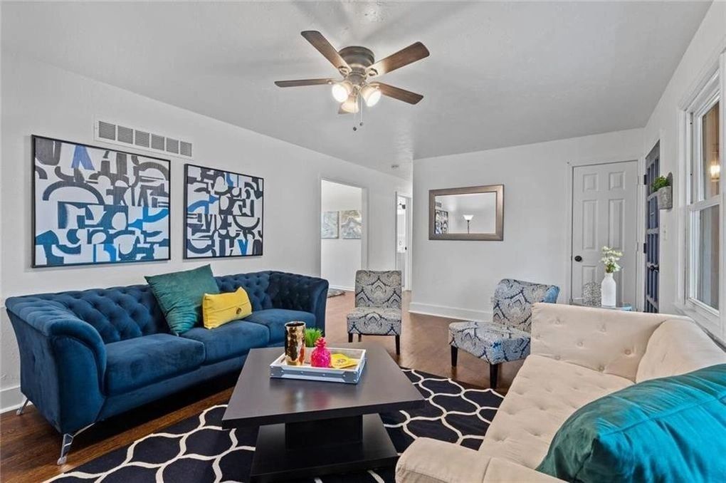 living room with decorative rug & artistic art paintings in the background