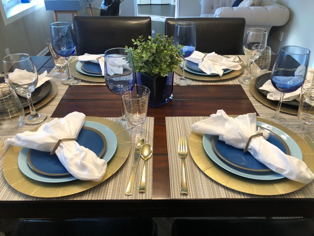 beautifully decorated tableware in a staged dining room