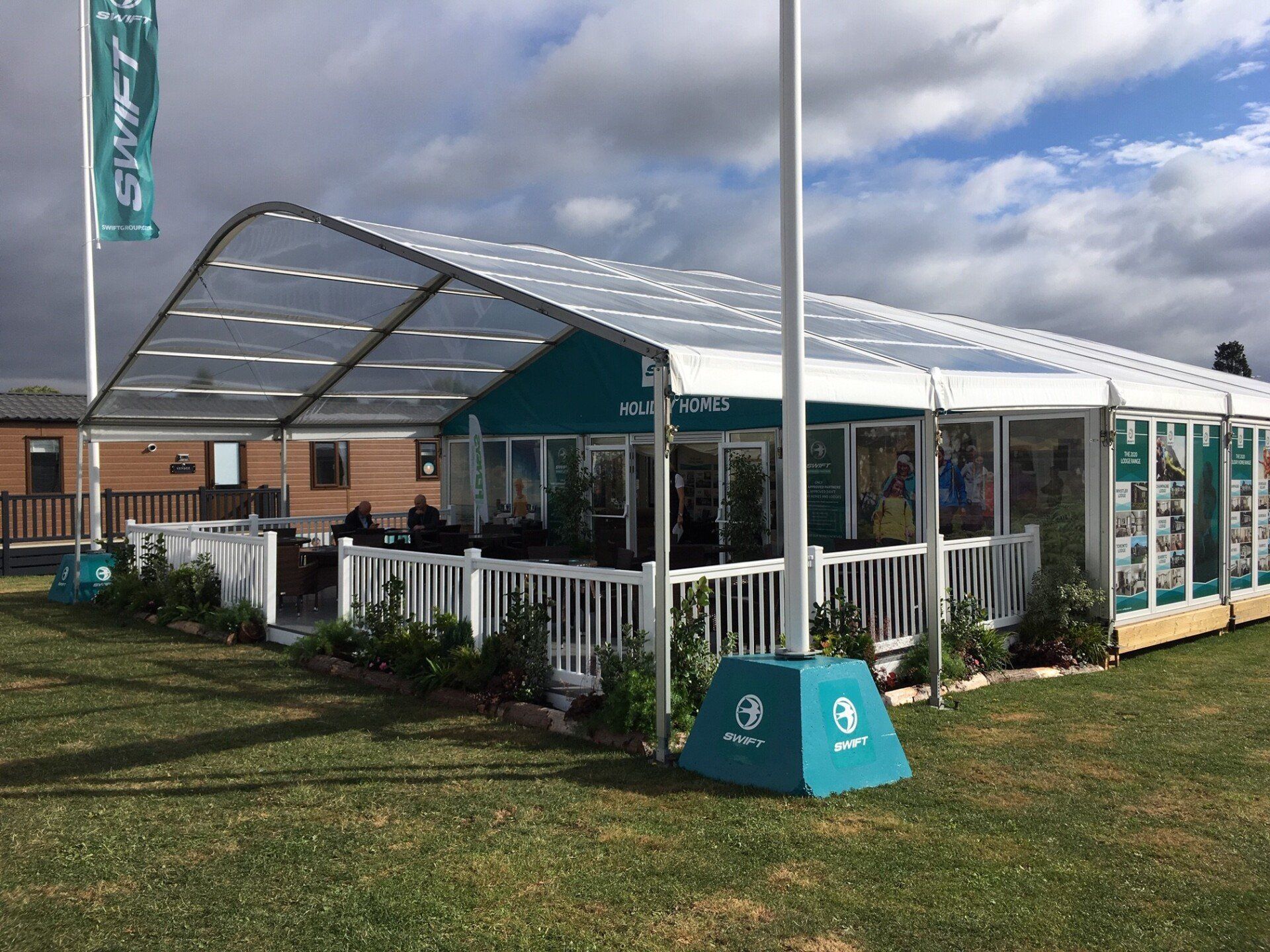 A large tent is sitting in the middle of a grassy field.