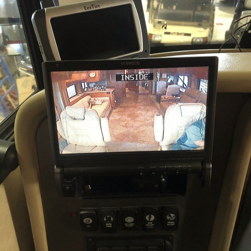 Car dashboard screen showing a room-view camera feed with the word “INSIDE” on top.