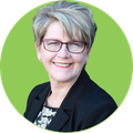 Woman wearing glasses, smiling, set against a green circle.