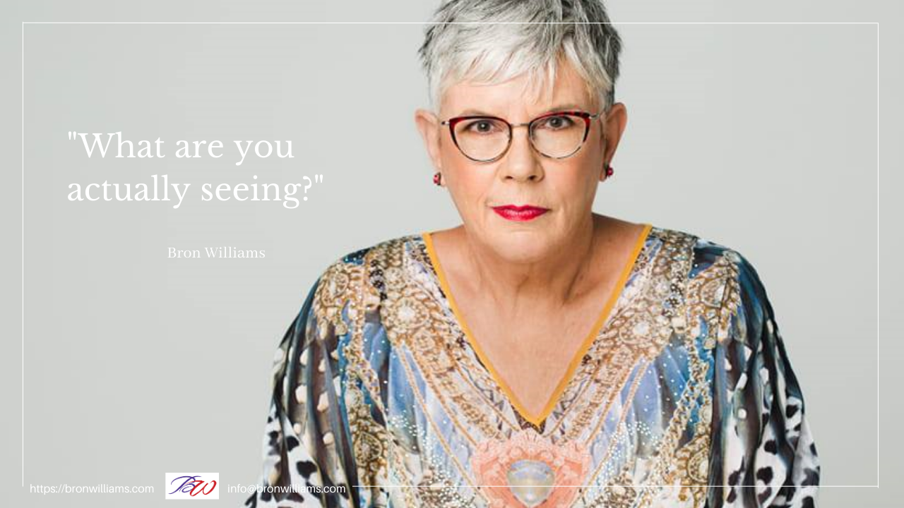 Woman wearing glasses and colorful top, text overlay: 