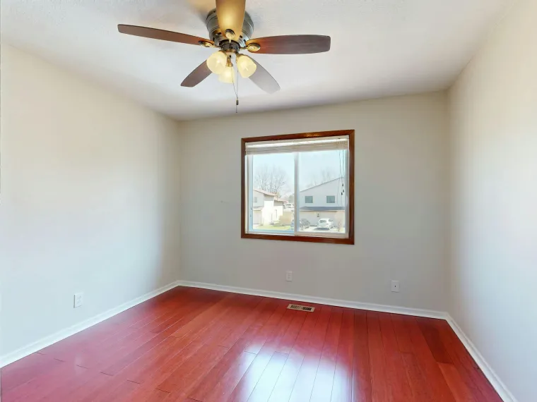 Empty Room With Red Hardwood Floor, White Walls, Ceiling Fan