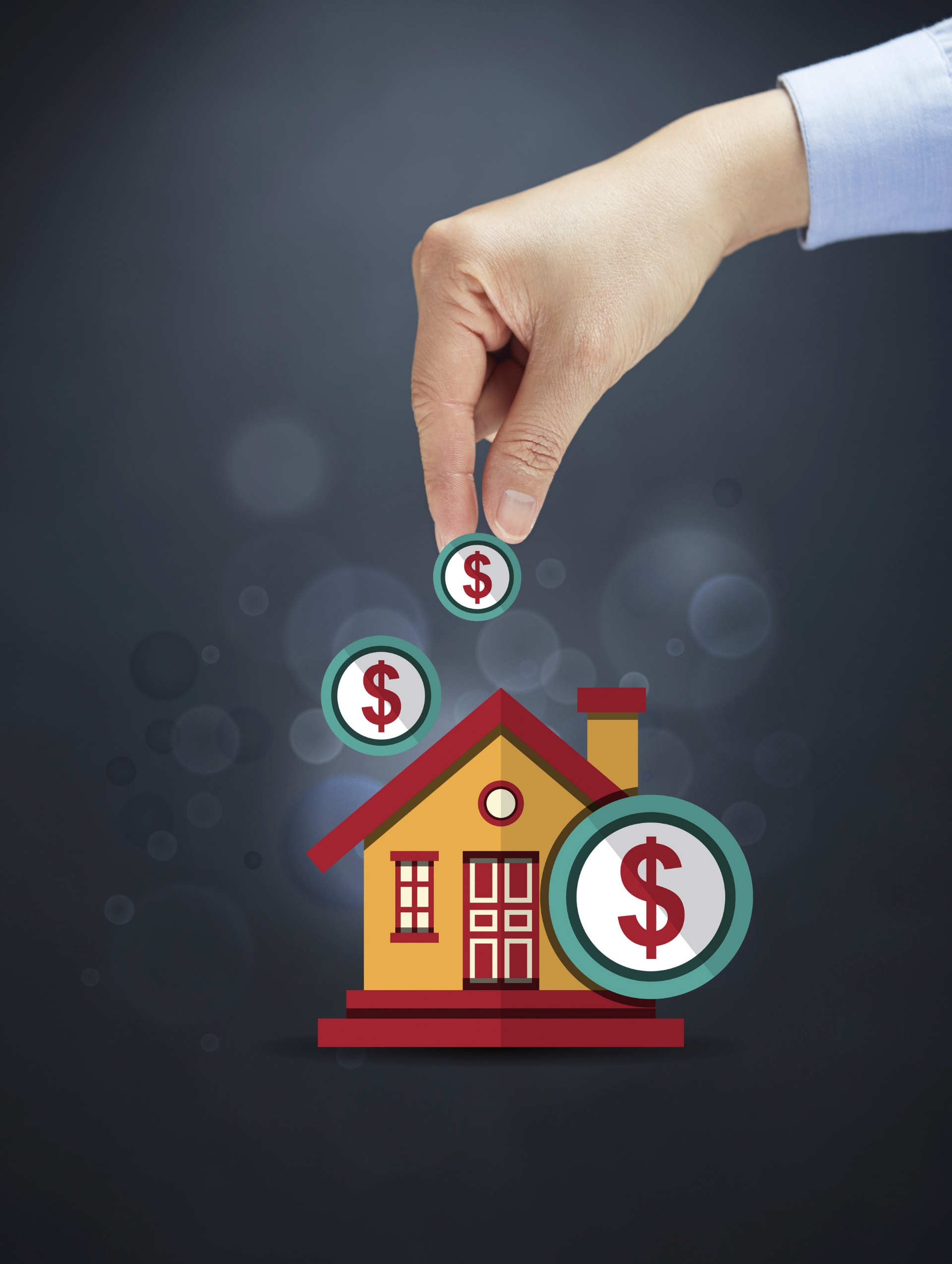 A hand is putting coins into a house with a dollar sign on it.