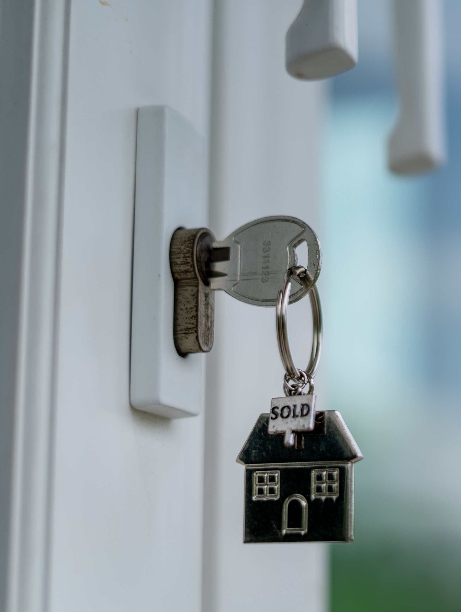 Apply Online A key with a house keychain attached to it.