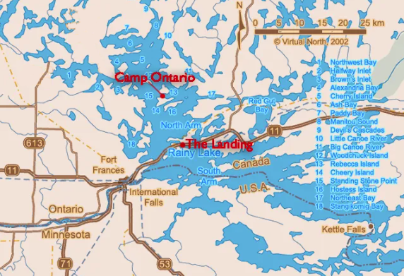 Map of a lake with islands, roads, and labeled camps in blue water and tan land