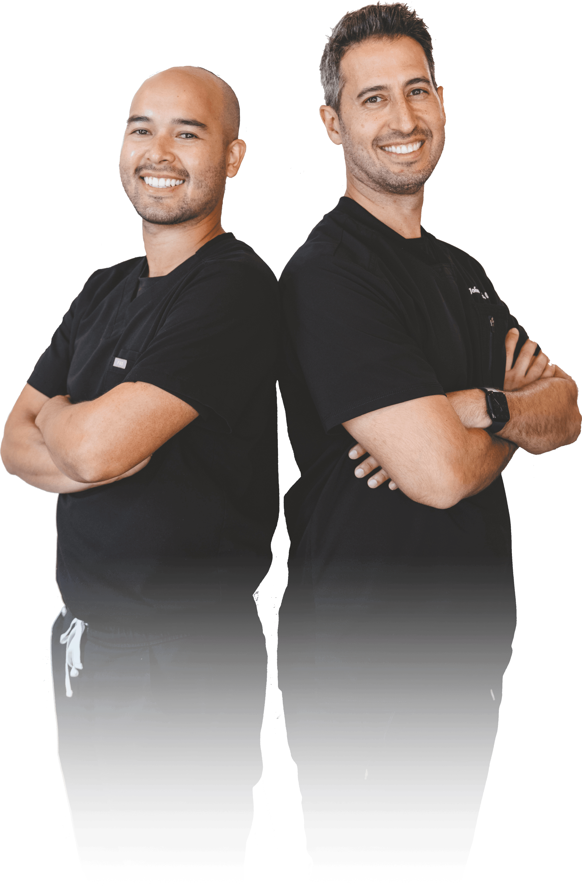 Two men are standing back to back with their arms crossed.