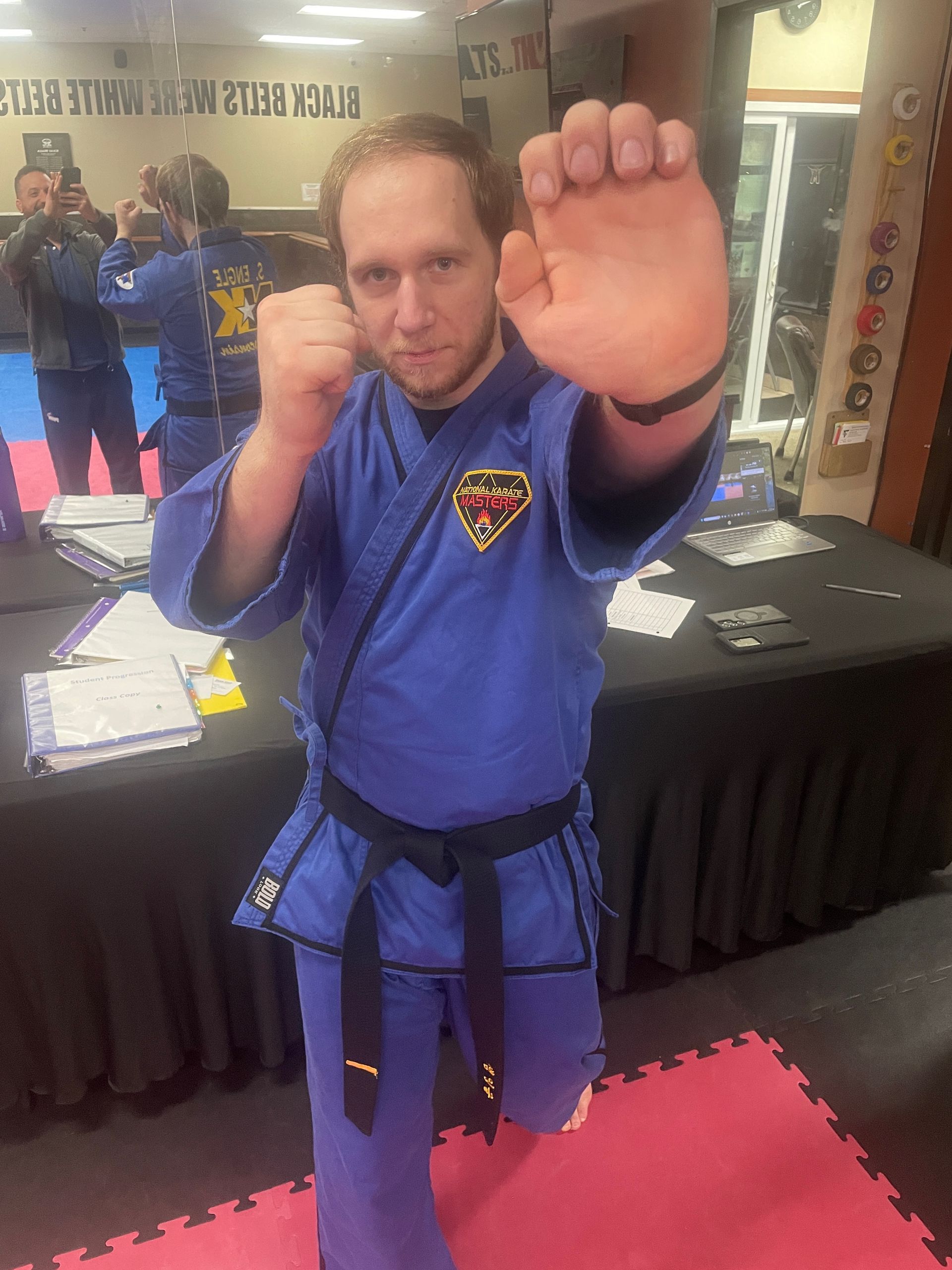 Adults practice jab-cross and roundhouse kicks at Wisconsin National Karate Kickboxing & Krav Maga.