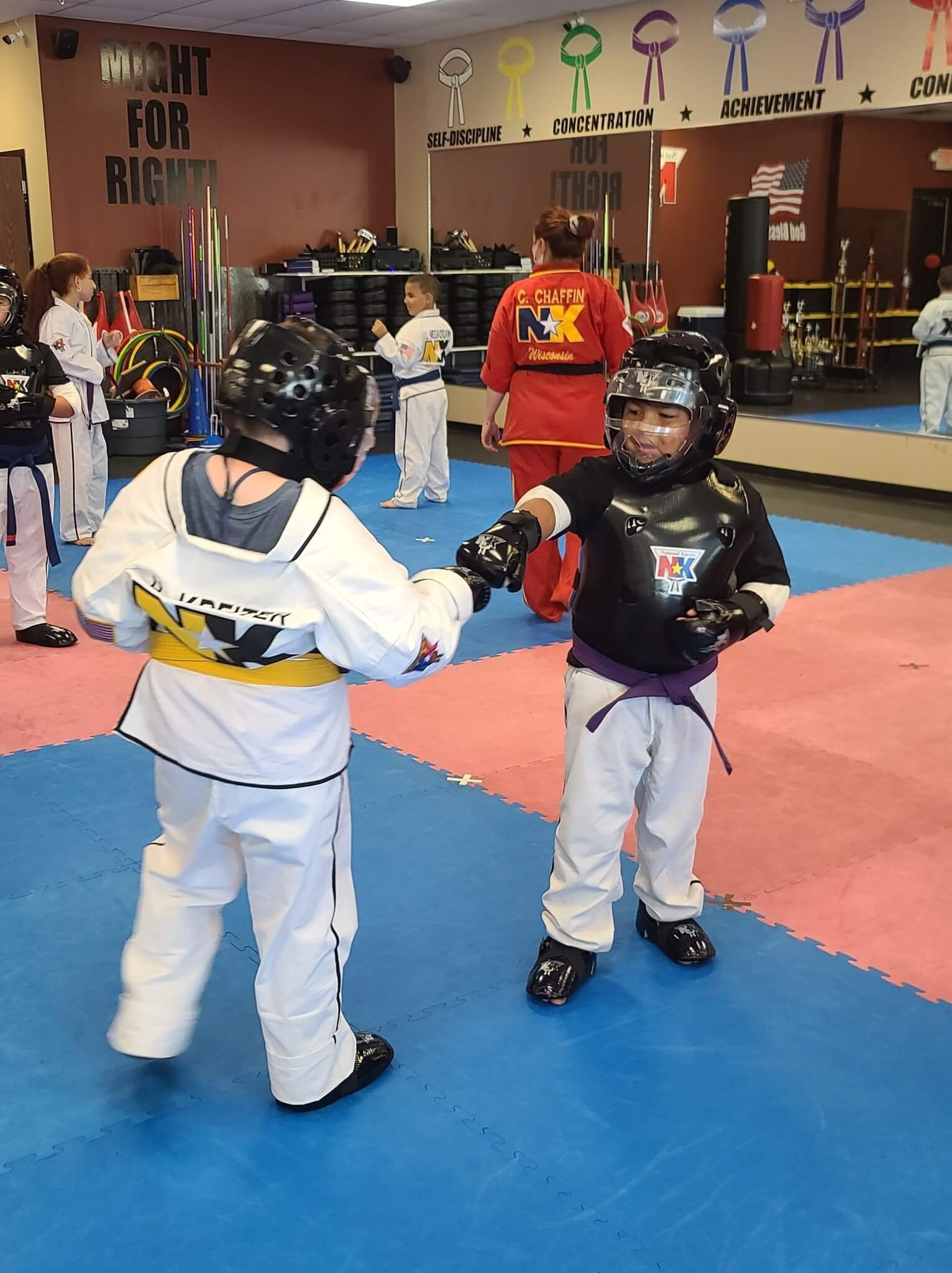 Kids and adults training Karate together at Wisconsin National Karate Kickboxing & Krav Maga in New Berlin, WI, building confidence.