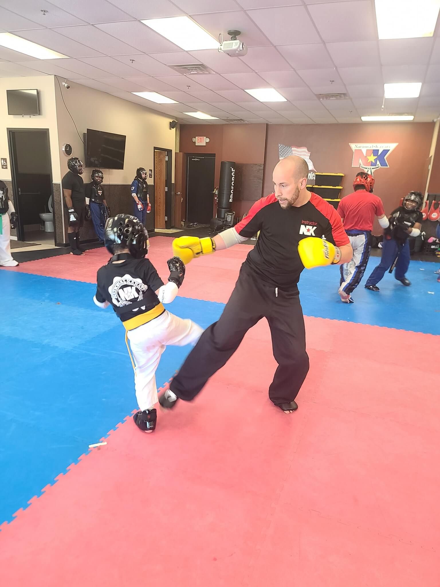 Kids practicing controlled karate drills at Wisconsin National Karate Kickboxing & Krav Maga in New Berlin, WI to build self-control.