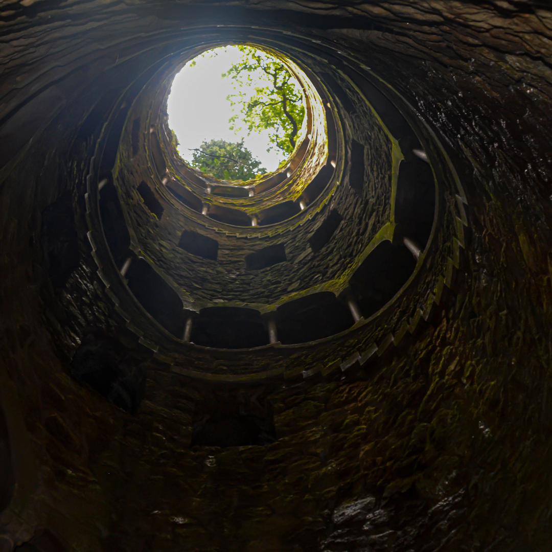 The sun is shining through the hole in the tunnel.