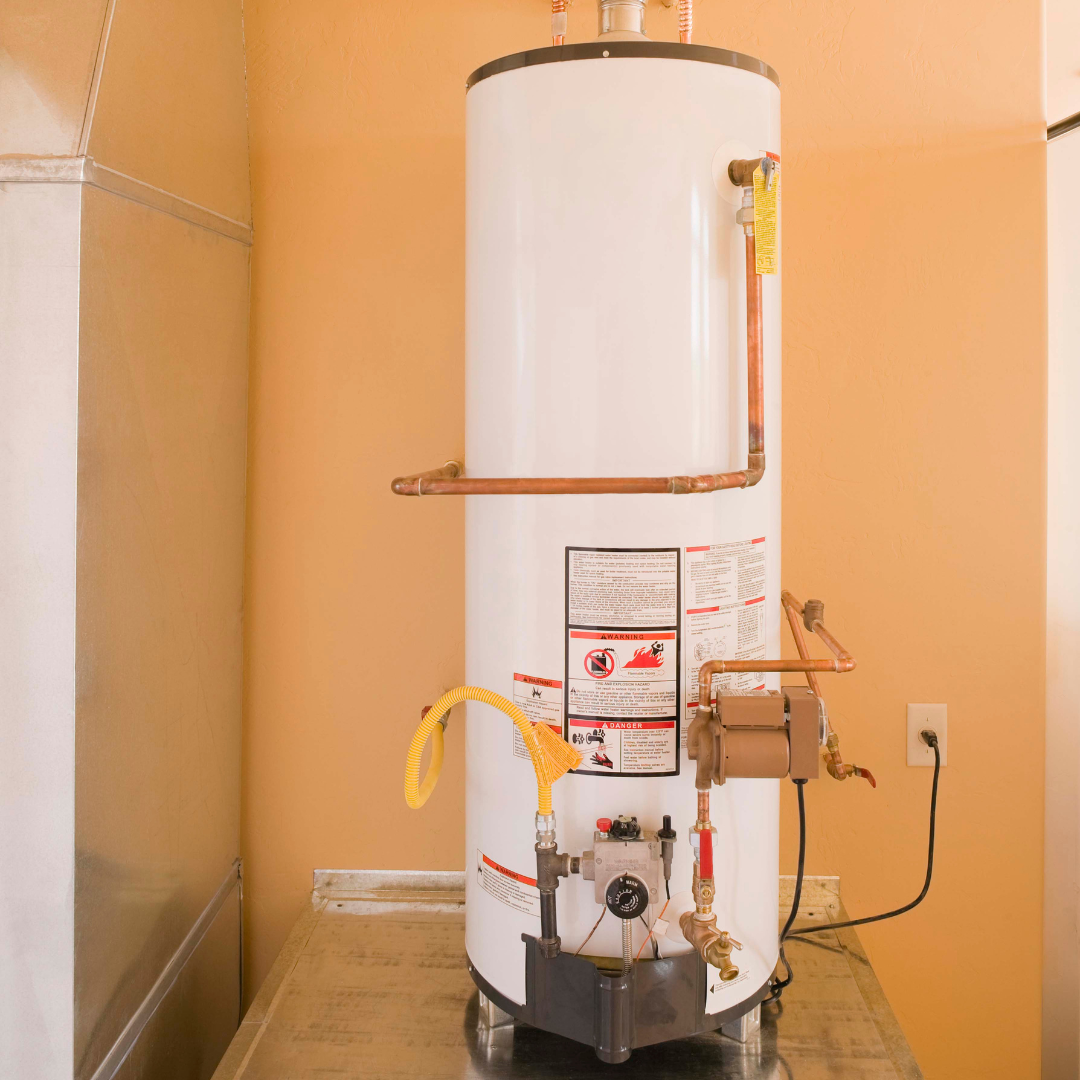 A white water heater is sitting on a counter in a room.